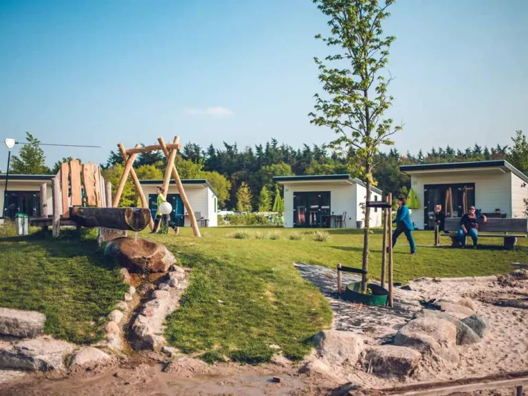 De Watervallei op Vakantiepark Ackersate, met zandbak, waterspeelbaan en klimtoestel voor de vakantiehuisjes